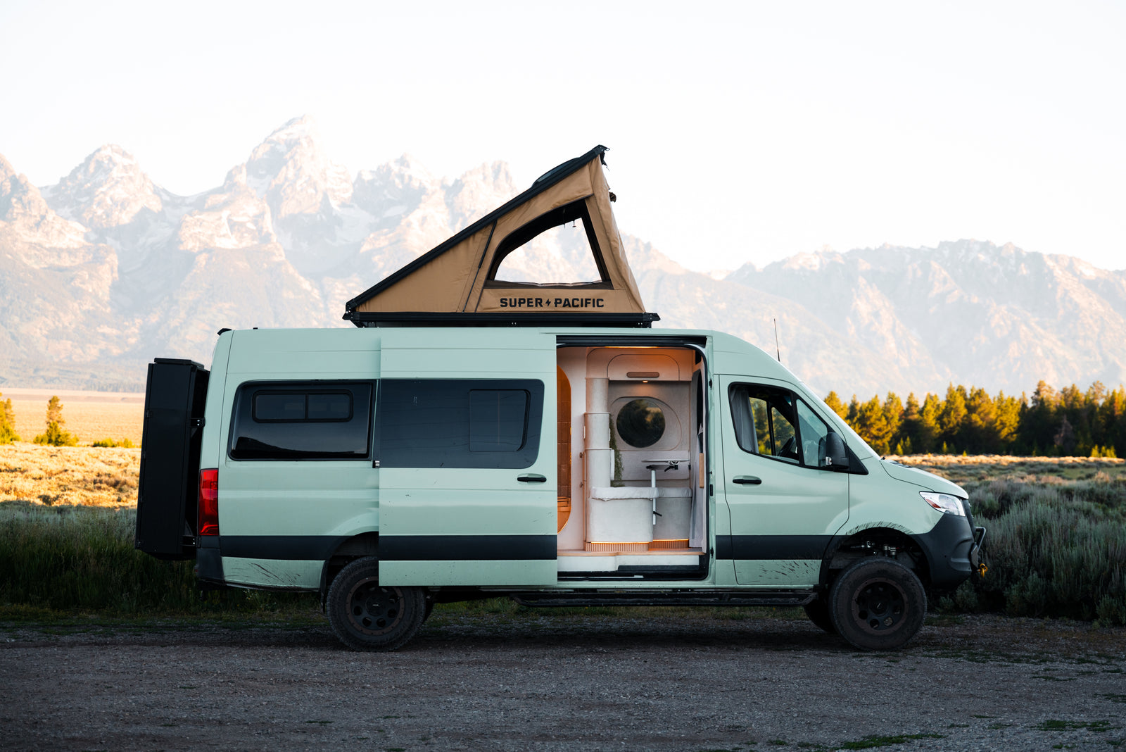 Flow in profile beneath the Tetons with its side door and rooftop tent open