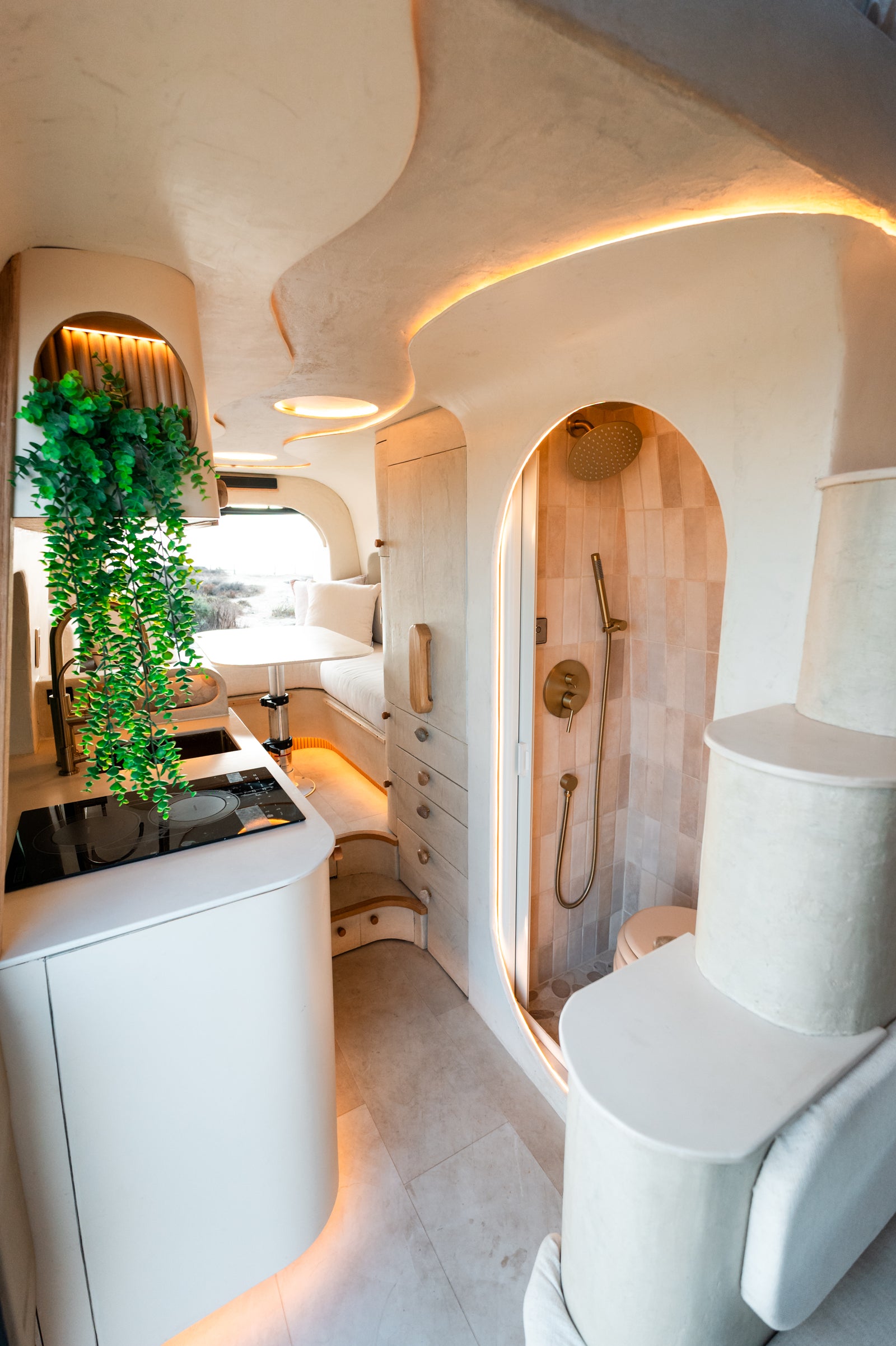 Flow's galley and arched tiled shower beneath the curved plaster ceiling