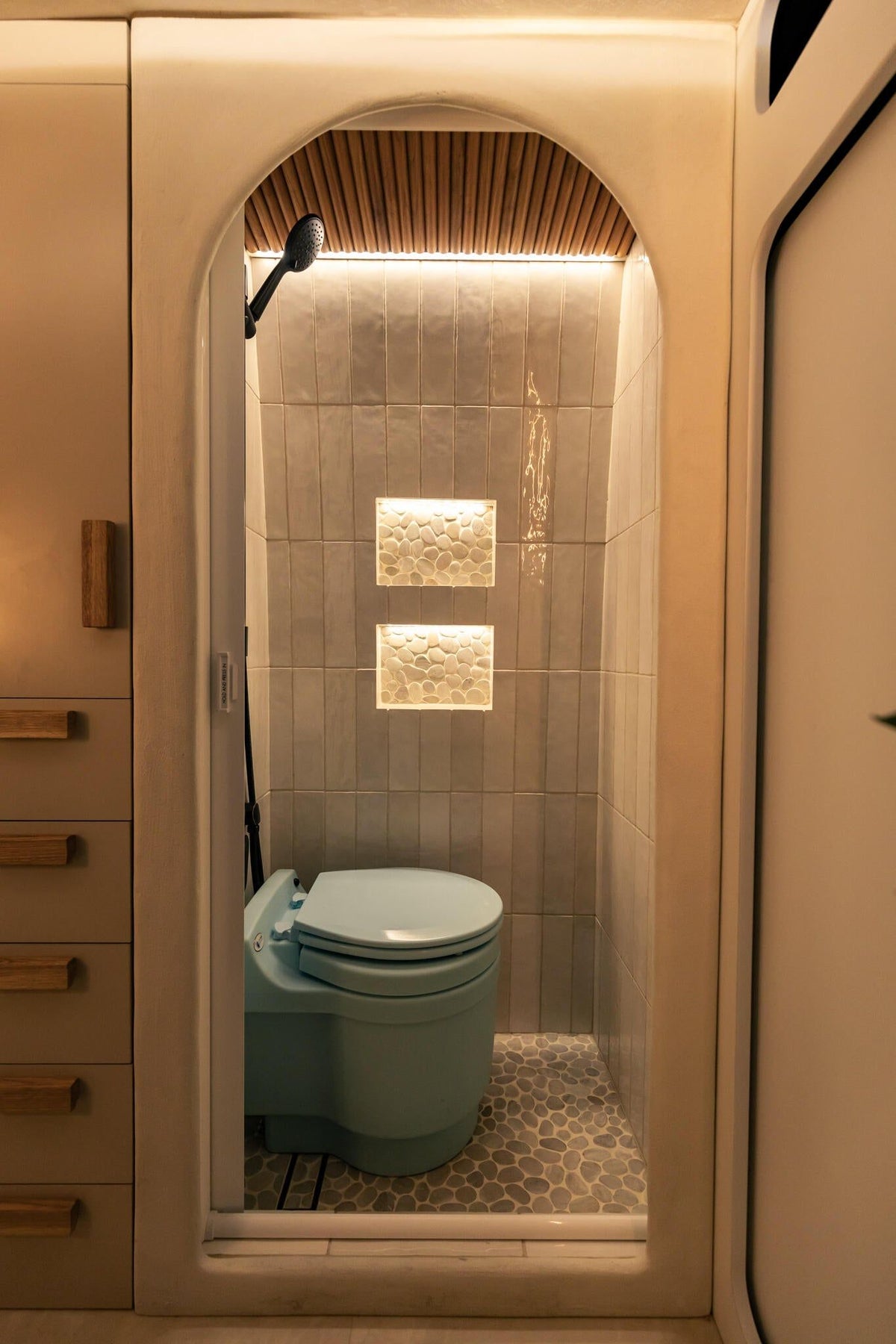 Luna bath — handmade Spanish tile and pebble accents.