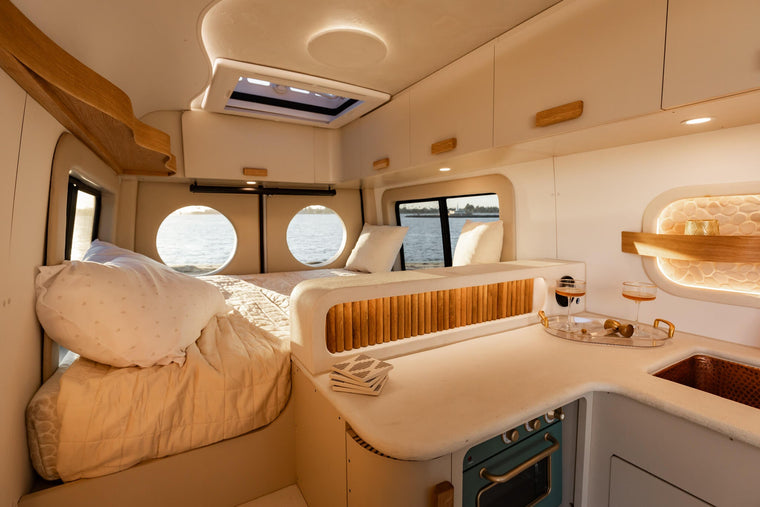 The Luna van bed with round windows over the water